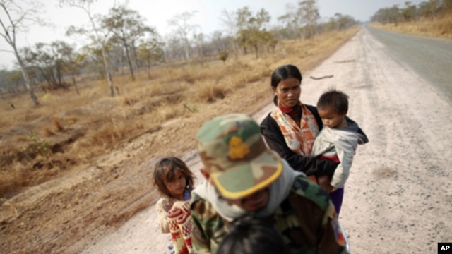 A Cambodian family is seen on an empty road as they flee the area near the 11th-century Preah Vihear temple on the border between Thailand and Cambodia, February 7, 2011.