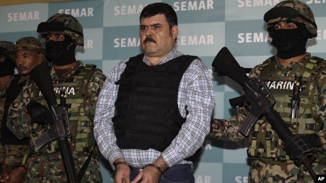 Mexican navy marines flank Jorge Eduardo Costilla Sanchez in Mexico City, Sept. 13, 2012.