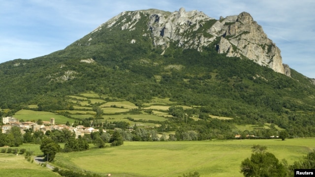The village and Peak of Bugarach, the highest point of the Corbieres massif, in southwestern France, is seen June 24, 2011. 
