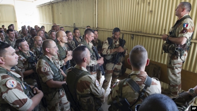 This picture released by the French Army shows French soldiers of the 21st Marine Infantry Regiment during a briefing before flying to Bamako, the capital from Mali, at the N'Djamena airport in Chad, Jan. 11, 2013.