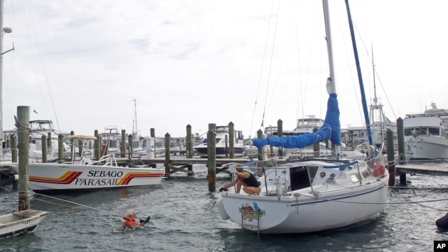 Craig Jones, left, and Kimberly Branson secure their boat in Key West, Fla., in preparation for Tropical Storm Isaac, August 26, 2012. 