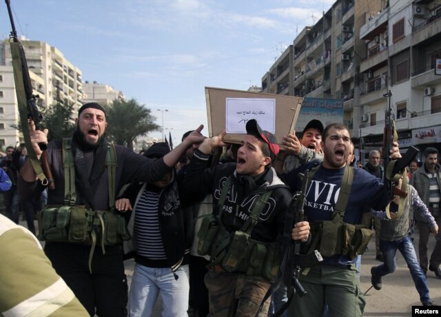 Lebanese Islamist gunmen fire their weapons as three bodies of other members of their group arrive from Syria, in Tripoli in northern Lebanon, December 9, 2012.