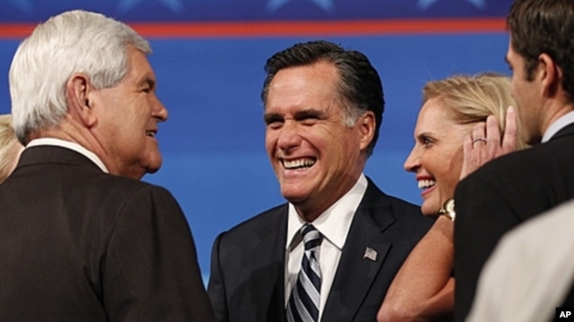 Former Mass. Governor Romney, wife talk to former Speaker of the U.S. House of Representatives Newt Gingrich in Orlando, Sept. 23, 2011.