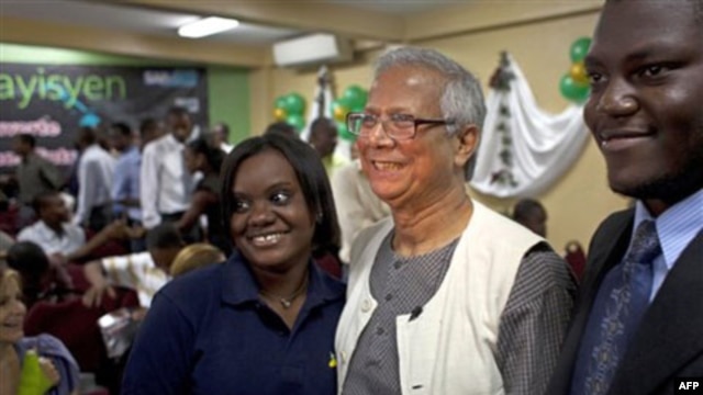 Muhammad Yunus has his picture taken with students at a technical school in Port-au-Prince, Haiti last year.  The school received a loan from a group headed by Mr. Yunus to help build social businesses. 