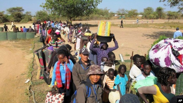 In this photo taken on Dec. 18, 2013, and released by the United Nations Mission in South Sudan, civilians fleeing violence seek refuge at the UNMISS compound in Bor, capital of Jonglei state, in South Sudan. 