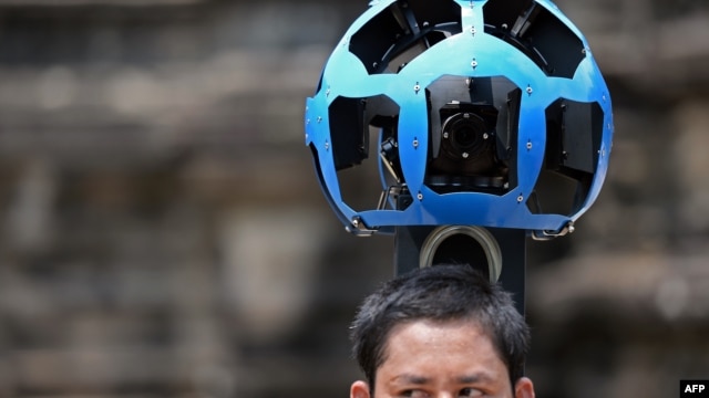 A Cambodian technician carries a back-pack mounted with a device housing 15 cameras as he demonstrates the technique used to digitally map the Angkor Wat temple, part of the Angkor architectural complex in north-western Cambodia on April 3, 2014. 