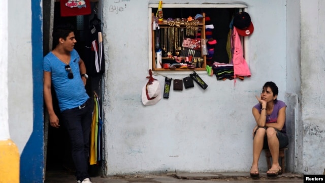 Vendors await customers at their private imported clothing outlet, Havana, Oct. 5, 2013.