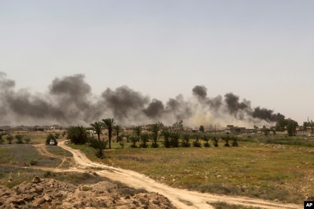 Smoke rises from Islamic State positions at the front line during fight against IS outside Fallujah, May 28, 2016.