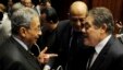 Amr Moussa (L), head of the assembly writing Egypt's new constitution, speaks with El-Sayed El-Badawi (R), the head of the Wafd party, before a vote at the Shura Council in Cairo, Dec. 1, 2013. 