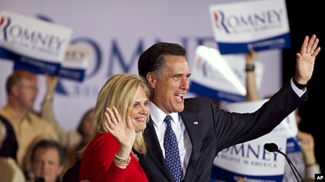 Republican presidential candidate Mitt Romney, right, and his wife Ann wave to a crowd in Schaumburg, Illinois, after Romney won the Illinois Republican presidential primary, March 20, 2012.