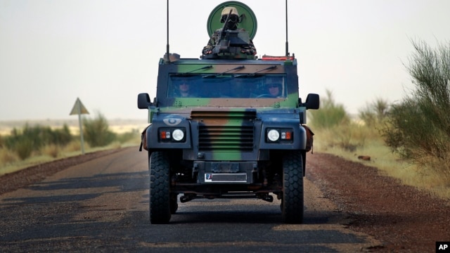 French soldiers in a British made armored car lead a  French supply convoy near Hambori, northern Mali, on the road to Gao, February 4, 2013.