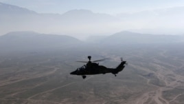 A German Bundeswehr armed forces Tiger attack helicopter flies next to the Marmal mountain near Camp Marmal in Mazar-e-Sharif, northern Afghanistan December 20, 2012.    REUTERS/Fabrizio Bensch (AFGHANISTAN - Tags: MILITARY CONFLICT POLITICS)