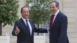 France’s President Francois Hollande, left, welcomes Greece's Prime Minister Antonis Samaras at the Elysee Palace, Paris, August 25, 2012.