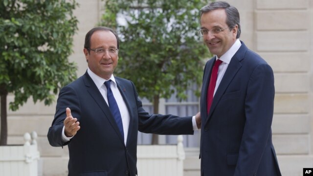 France’s President Francois Hollande, left, welcomes Greece's Prime Minister Antonis Samaras at the Elysee Palace, Paris, August 25, 2012.