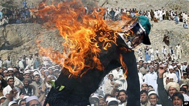Effigy of the American pastor Terry Jones is seen burning during a demonstration in Shinwar, Nangarhar province, east of Kabul, Afghanistan, after protests erupted in Afghanistan again Monday against the Florida pastor's burning of the Quran, April 4, 201