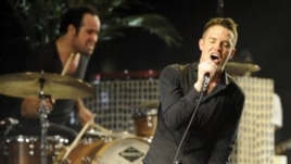 Singer Brandon Flowers and drummer Ronnie Vannucci of The Killers performs during Coachella Valley Music & Arts Festival in Indio, California
