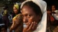 FILE - Rohingya people wait to receive their share of food aid from the World Food Program (WFP) at the Thae Chaung camp for internally displaced people in Sittwe, Rakhine state.