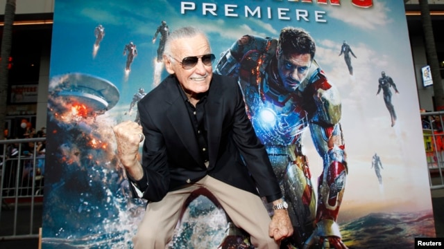 FILE- Stan Lee gestures as he poses at the premiere of "Iron Man 3" at El Capitan theater in Hollywood, California, April 24, 2013.