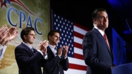 Republican presidential candidate Mitt Romney is applauded by sons Josh, center, and Tagg, left, as he speaks at a Colorado Conservative Political Action Committee meeting in Denver, Oct. 4, 2012.