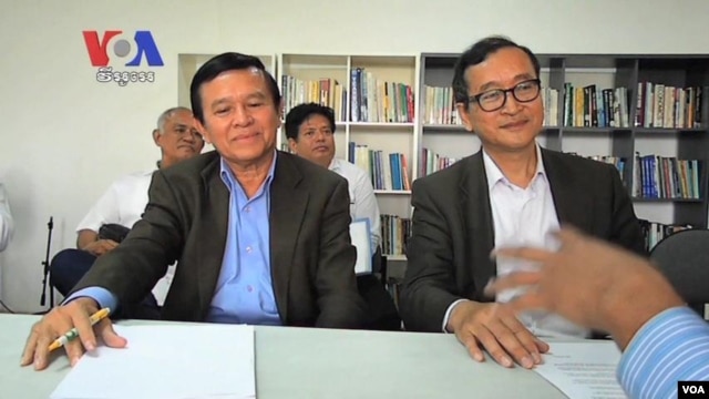 Kem Sokha, left, leader of Human Rights Party sitting alongside with Sam Rainsy, leader of Sam Rainsy Party, in Manila last month. 