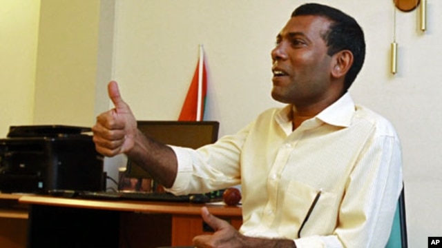 Former Maldivian president Mohamed Nasheed speaks with the media at his home in Male, February 9, 2012.