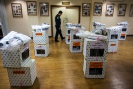 A policeman walks next to election boxes ready to be delivered to polling stations in the Don Muaneng district office in Bangkok, Thailand, Feb. 1, 2014.