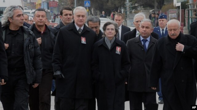 U.S. Ambassador to Turkey, Francis J. Ricciardone, third left, and his wife Marie arrive to attend the funeral ceremony for Mustafa Akarsu, an embassy security guard killed when a suicide bomber struck the American Embassy in Ankara, February 2, 2013. 