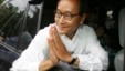 FILE - In this July 27, 2008 photo, Sam Rainsy leader of Sam Rainsy Party greets his supporters after casting his vote at a polling station in kampong Cham province north of  Phnom Penh.