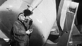 Edwin Hubble looks through a guidescope of the 1.2 meter telescope at the Palomar Observatory in California.