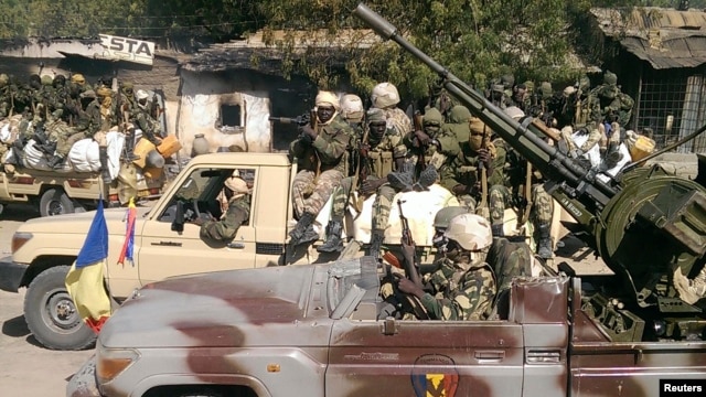 FILE - Chadian soldiers drive through the streets of Gambaru, Nigeria, Feb. 4, 2015.