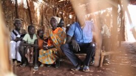 After queueing for soap, refugees in Yida camp gather in a straw hut to learn about basic sanitation and hand washing, in South Sudan's Upper Nile, August 2012. (VOA - H. McNeish)
