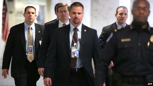 Acting CIA Director Michael Morell (2nd L) arrives Capitol Hill to attend closed-door meetings before the Senate Select Intelligence Committee, Washington, November 15, 2012.