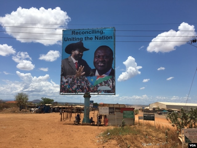 FILE - A billboard in South Sudan's capital, Juba, on April 15, 2016 shows South Sudan's President Salva Kiir (L), and rebel leader Riek Machar (R). (VOA/J. Patinkin)