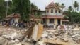 People stand next to debris after a broke out at a temple in Kollam in the southern state of Kerala, India, April 10, 2016. A huge fire swept through a temple in India's southern Kerala state early on Sunday (April 10).