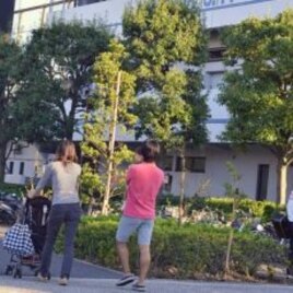 A family strolling past the Edogawa City Baseball Stadium, near where high levels of radiation has been detected this month, Japan, October 15, 2011.
