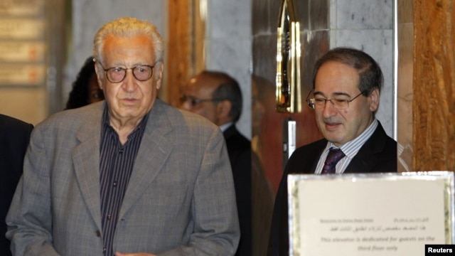 Syria's Deputy Foreign Minister Faisal Mekdad (R) welcomes U.N.-Arab League peace envoy for Syria Lakhdar Brahimi at a hotel in Damascus, October 19, 2012. 
