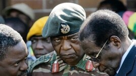 President Roberty Mugabe consulting some members of the Joint Operations Command in Harare