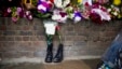 In this Friday, May 24, 2013 file photo, military boots are laid in tribute outside the Woolwich Barracks, in London, in response to the bloody attack on Wednesday when a British soldier was killed in the nearby street. 