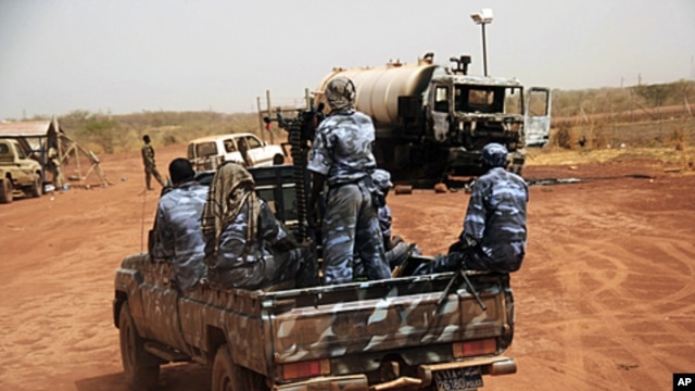 Sudanese armed forces ride a military vehicle at the oil-rich border town of Heglig, Sudan, April 24, 2012.