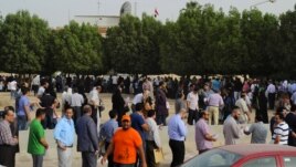 Egyptian nationals living in Kuwait stand in line at the entrance of the Egyptian Embassy before voting in Egypt's presidential elections, in Bnaid al-Gar, Kuwait, May 16, 2012.