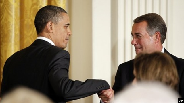 U.S. President Barack Obama greets House Speaker John Boehner before delivering remarks at a dinner of bipartisan committee chairmen and ranking members and their spouses at the White House, May 2, 2011