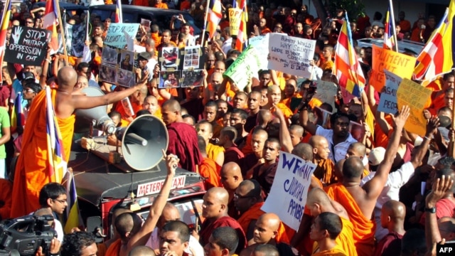 Sri Lankan Buddhist monks shout slogans and hold placards as they stage a protest rally outside the Bangladesh High Commission in Colombo, October 4, 2012.