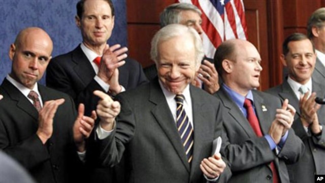 Senator Joseph Lieberman, center, gestures during a news conference pushing for the repeal of the military 'Don't Ask Don't Tell' rule, Capitol Hill, Washington, DC, 18 November 2010