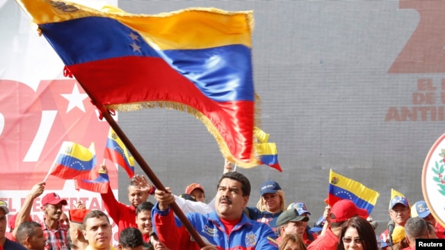 This Venezuelan government photo shows President Nicolas Maduro waving a flag to celebrate the anniversary of the