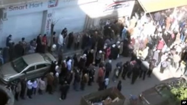 This image from amateur video made available by Shaam News Network purports to show people gathered in Homs, Syria, February 12, 2012.
