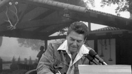 President Ronald Reagan signs a major tax cut bill at his ranch near Santa Barbara, California