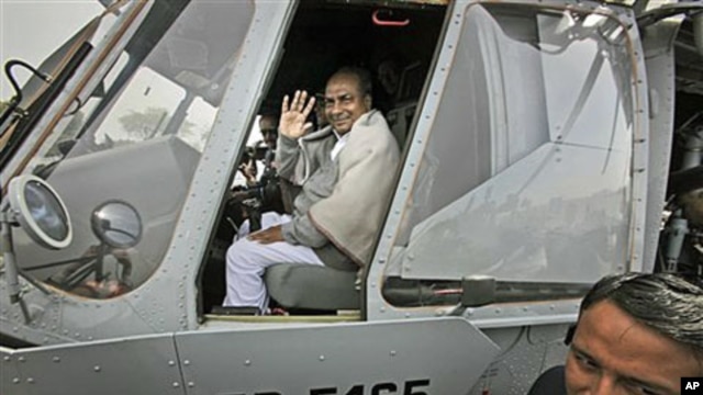 Indian Defense Minister A.K. Antony waves while sitting in the cockpit of an Indian Air Force Mi-17 V5 helicopter during its induction ceremony in New Delhi, India, Feb. 17, 2012.