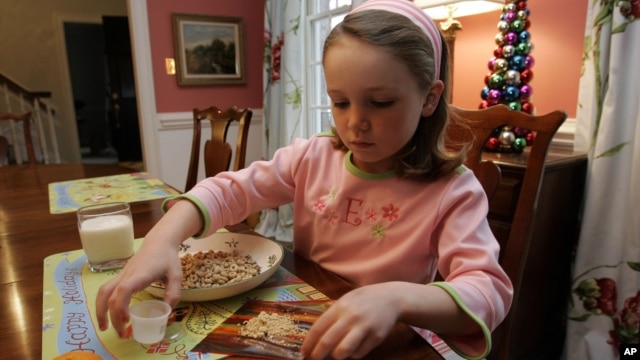 Elizabeth White has a peanut allergy, mixes peanut powder with a fruit roll-up to buildup her tolerance, December 21, 2006. 