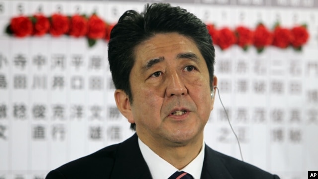 Japan's main opposition leader Shinzo Abe of the Liberal Democratic Party answers a reporter's questions at the party headquarters in Tokyo, Dec. 16, 2012.