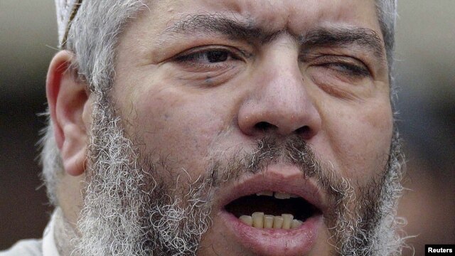 Muslim cleric, Abu Hamza al-Masri, leads prayers at the North London Central Mosque in Finsbury Park, February 7, 2003.